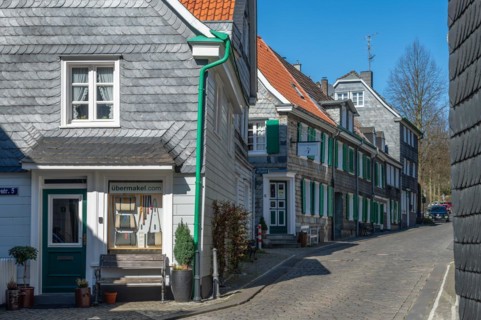 Street view with traditional German half-timbered houses and cobblestones on a sunny day,