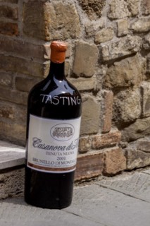 Giant wine bottle as an advertisement and invitation to a wine tasting in front of a wine shop,