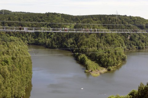 Visitors cross the rope suspension bridge at the Rappbode dam, 483 metres long, 100 metres above