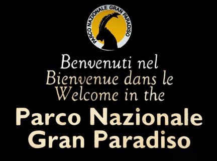 Wooden welcoming board with logo of the Gran Paradiso National Park in the Graian Alps, Italy,