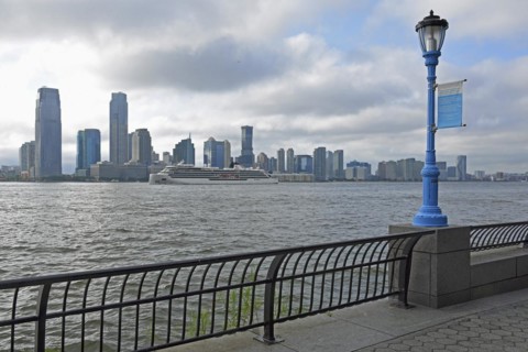 Street lamp marking the potential future flood level caused by global warming, in the background