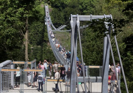 Visitors cross the rope suspension bridge at the Rappbode dam, 483 metres long, 100 metres above