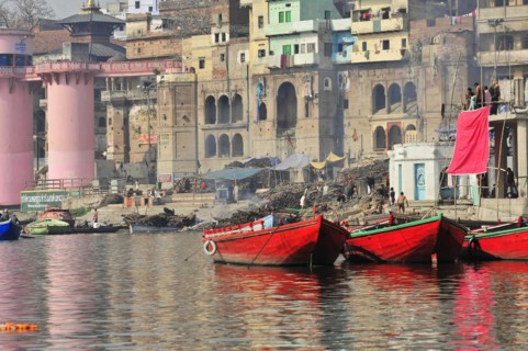 Boat in front of the ghats of a river in India, where laundry is hung out to dry, Varanasi, Uttar