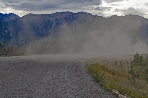 Long plume of dust on a gravelled section of the Alaska Highway, Yukon Territory, Canada, North