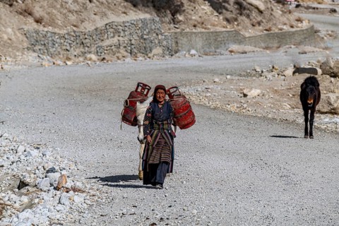 Tibetan women walking with her horse, Garphu, Kingdom of Mustang, Nepal, Asia