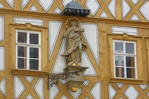 Madonna figure with halo on a yellow half-timbered house, detail, house wall, window, yellow, main