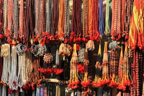 Colourful necklaces and beads hanging in a market stall, presented for sale, Varanasi, Uttar