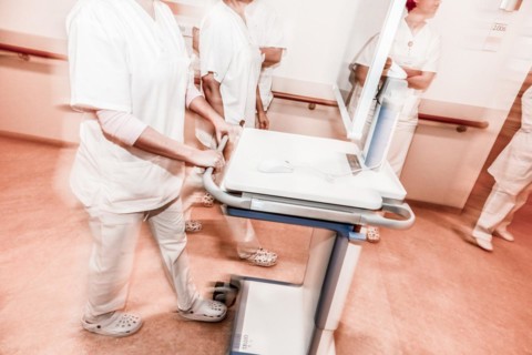 Nurses and care staff walk down a corridor in a hospital in Berlin with the digital patient file,