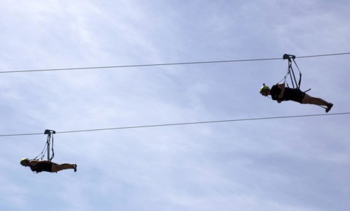 Two men use a zipline to fly over a 1, 000 metre stretch of the Rappbode Reservoir. The zipline,