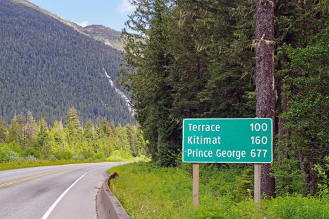 Road sign with distances on the Yellowhead Highway, no traffic, wilderness, Terrace, Kitimat,