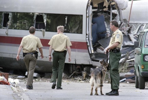 Police officers stand next to a destroyed ICE train carriage on 6 June 1998 in Eschede. 102 people