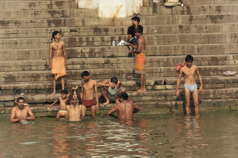 People performing ritual bathing and social interactions at the ghats of a river, Varanasi, Uttar