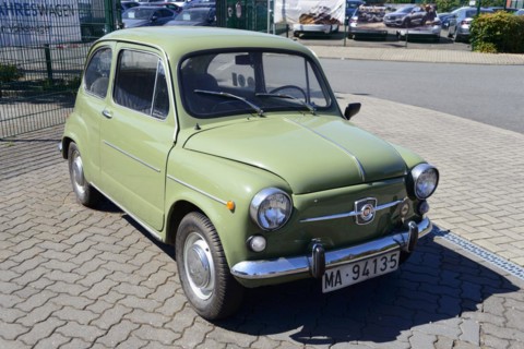 Front view of a green vintage Fiat parked on a cobbled street, Seat 600 E, Peine, Lower Saxony,