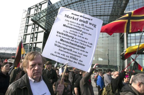 A participant in the Merkel muss weg demo. Demonstration by right-wing populist and far-right