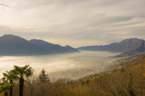 Sea of Fog and Mountain Valley over Locarno in Ticino, Switzerland, Europe