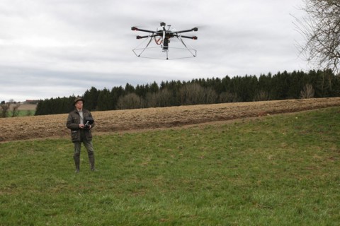 Hunter observes and controls flying drone during a hare (Lepus europaeus) census, Lower Austria,