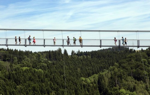 Visitors cross the rope suspension bridge at the Rappbode dam, 483 metres long, 100 metres above