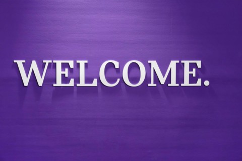 A simple purple wall with 'WELCOME.' in white lettering as a greeting, BMW WELT, Munich, Germany,