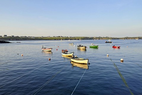 Boats on the blue waters of a bay, Ouessant Island, Finistere, Brittany, France, Europe