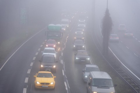 Cars driving on a foggy road with poor visibility in the grey daylight, Magdeburg, Saxony-Anhalt,