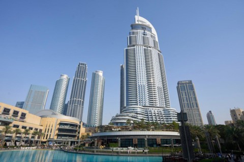 Tourists in front of the skyscraper backdrop at Lake Burj Khalifa. Dubai, United Arab Emirates,