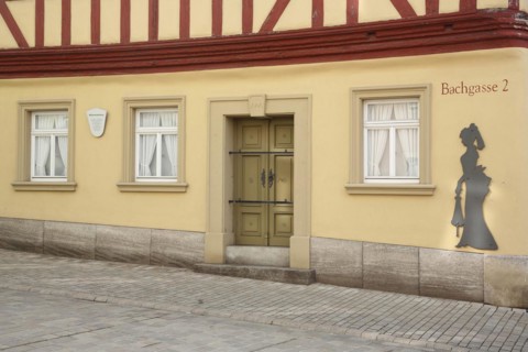 Historic painter's corner house built in 1774 and museum, female figure, lady, silhouette, alleyway