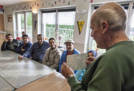 Syrian refugees learn traffic rules during an integration course. An employee of the