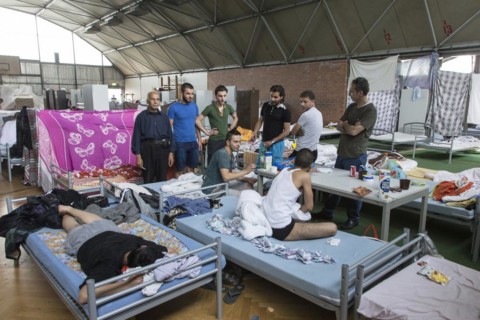 Refugees from Syria are housed in a gymnasium at the central contact point for asylum seekers in