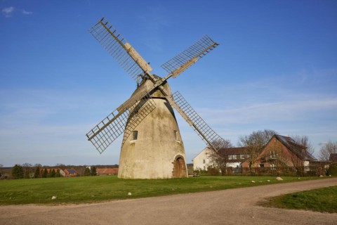 Windmill Auf der Hoechte under a cloudless blue sky is part of the Westphalian Mill Road in Hille,