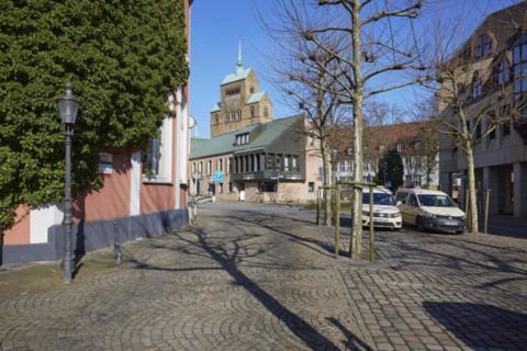 City centre with cobblestones, lantern, taxis at the taxi rank and commercial buildings and the