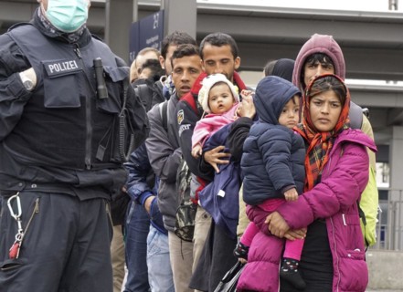 Refugees arriving at Rosenheim station, being taken to registration by federal police officers,