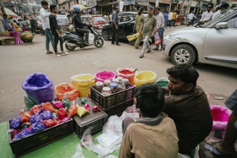 Vendor sells Holi celebration items in a street market, ahead of Holi festival on March 23, 2024 in