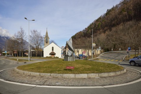 Bell tower with church Clocher de la chapelle St. Michel and art in the roundabout by Antoine