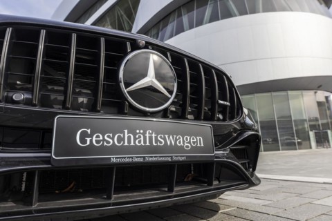 Mercedes company car, radiator grille and Mercedes star on a modern vehicle, in the background the