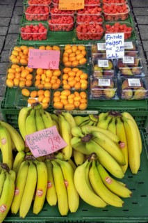 A fruit stand with figs, raspberries, kumquats (Fortunella), and bananas in mid-March, Kempten,