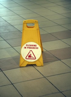 Plastic bollard notice on floor area that cleaning is in progress