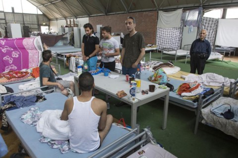 Refugees from Syria are housed in a gymnasium at the central contact point for asylum seekers in