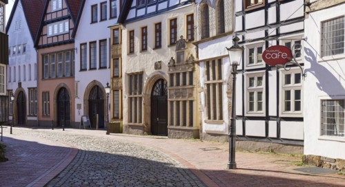 Historic facades, lantern and sign for the cafe with backlight in the Schnurrviertel in the old