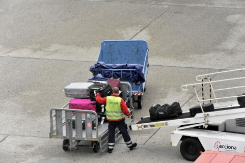 Airport employee operating a luggage trolley on the tarmac, Hamburg, Hanseatic City of Hamburg,
