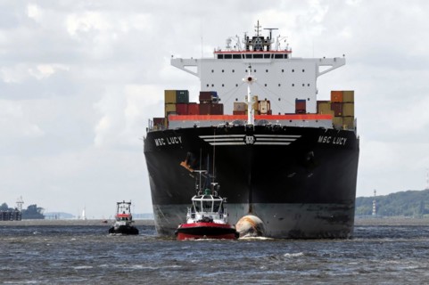 MSC LUCY, bow view of a large container ship, accompanied by tugboats, Hamburg, Hanseatic City of