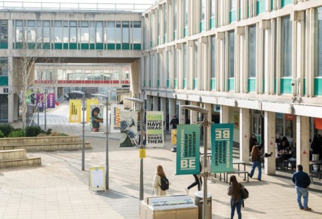 Students walking in campus square area, University of Essex, Colchester, Essex, England, UK
