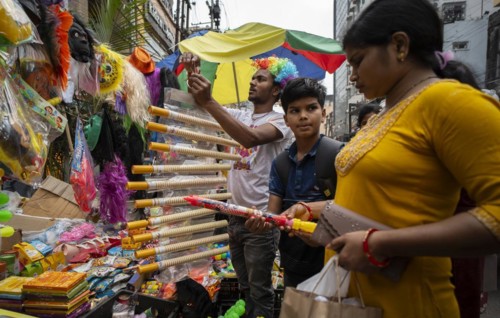 Vendor sells Holi celebration items in a street market, ahead of Holi festival on March 23, 2024 in