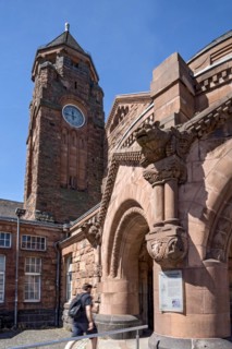 Historic Wilhelmine railway station, clock tower, pavilion with gargoyle, entrance to the station