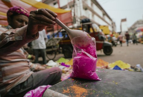 Vendor sells Holi celebration items in a street market, ahead of Holi festival on March 23, 2024 in