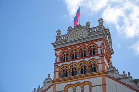 Tower with decorations and flag of St Matthias Church, Benedictine Abbey, Trier,