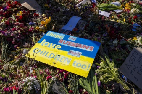 Mourners with flags and flowers in front of the Russian Embassy Unter den Linden, Berlin, Germany,