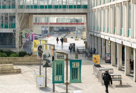 Students walking in campus square area, University of Essex, Colchester, Essex, England, UK