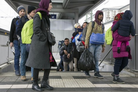 Refugees arriving at Rosenheim station, being taken to registration by federal police officers,
