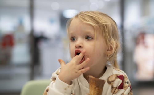 Interior shot, girl, 2-3 years, blonde, eating chocolate ice cream, ice cream, waffle, mouth