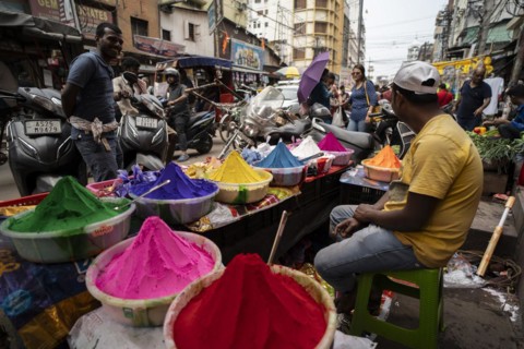 Vendor sells Holi celebration items in a street market, ahead of Holi festival on March 23, 2024 in